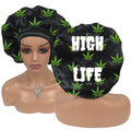 Black satin bonnet with marijuana leaf pattern and 'HIGH LIFE' text on a mannequin head and stand.